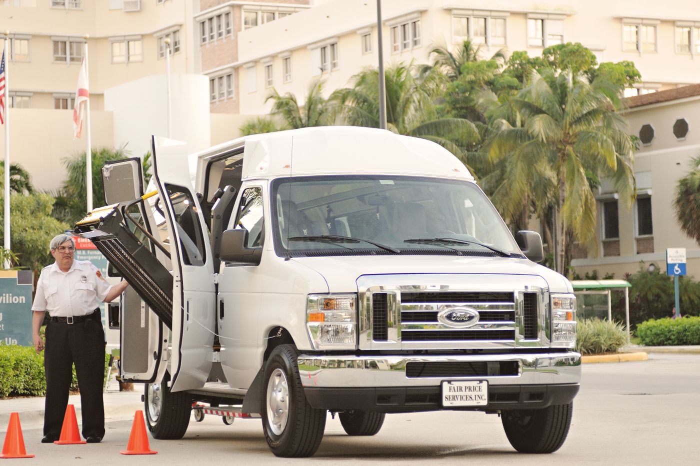 A white passenger van with its wheelchair lift lowered