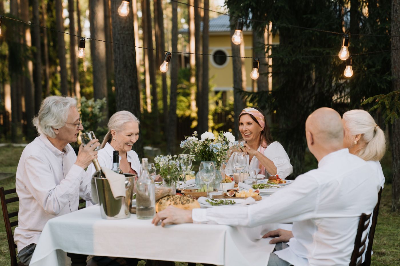Seniors sharing a meal together at a long table