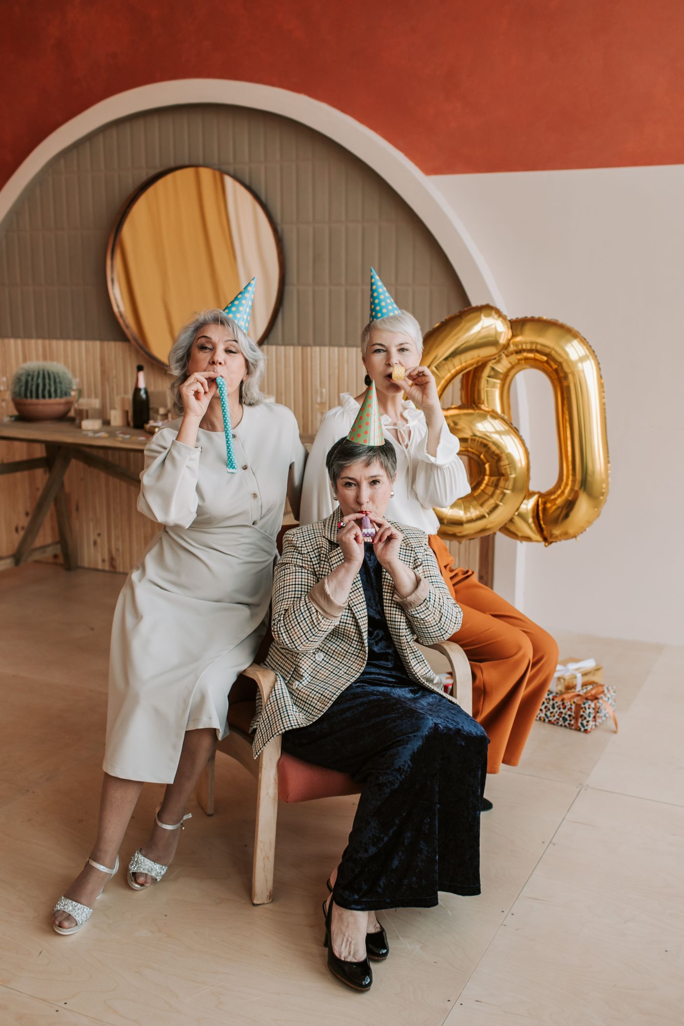 Members in party hats celebrating an 80th birthday