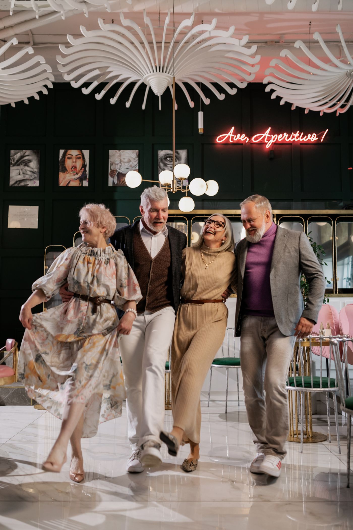 Four seniors laughing and dancing together